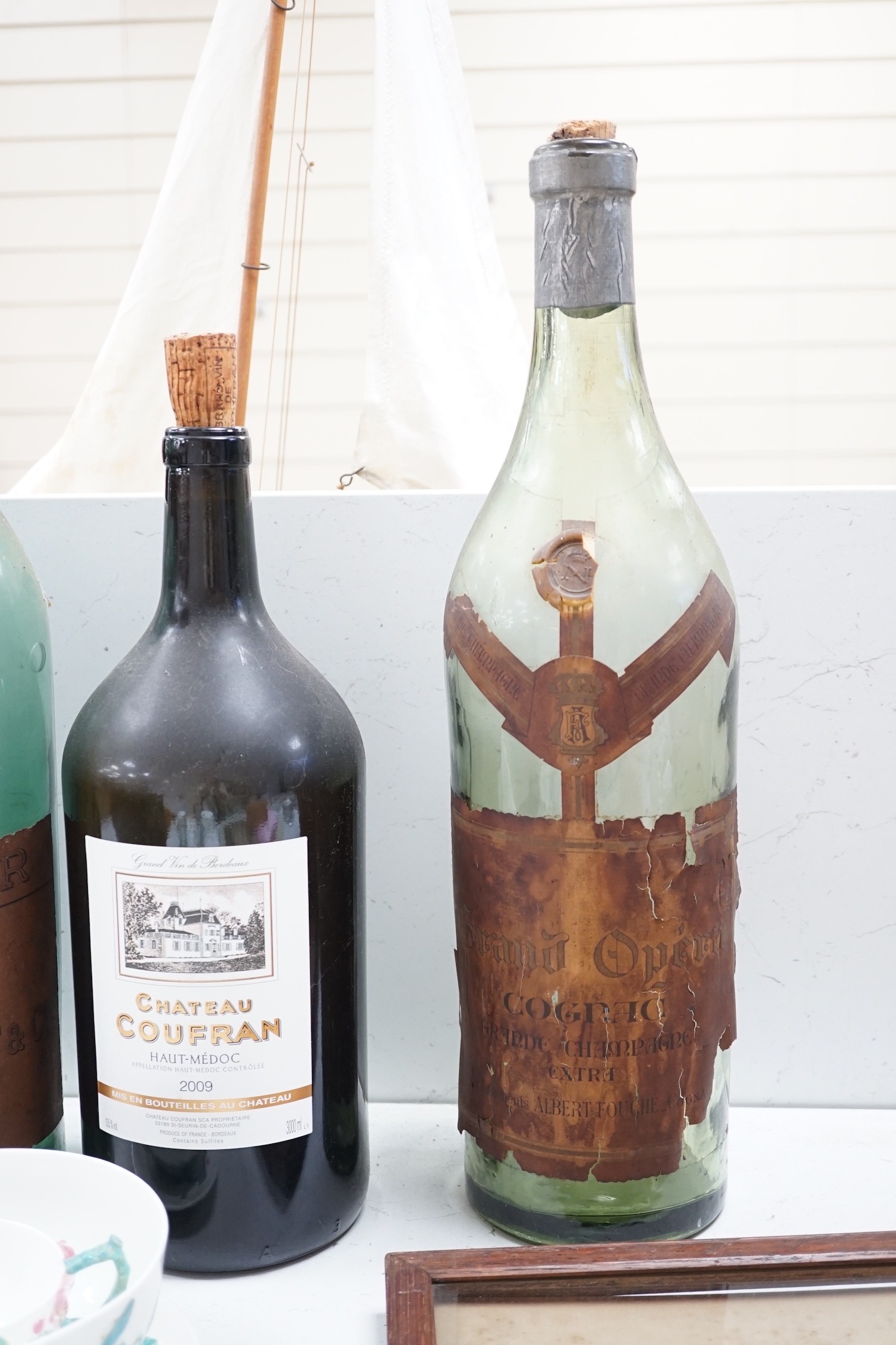 A collection of oversize and advertising bottles for Cinzano, Courvoisier, Moet Chandon, Rouyer Guillet cognac, Grand Opera cognac and Chateau Coufran, largest 52 cm